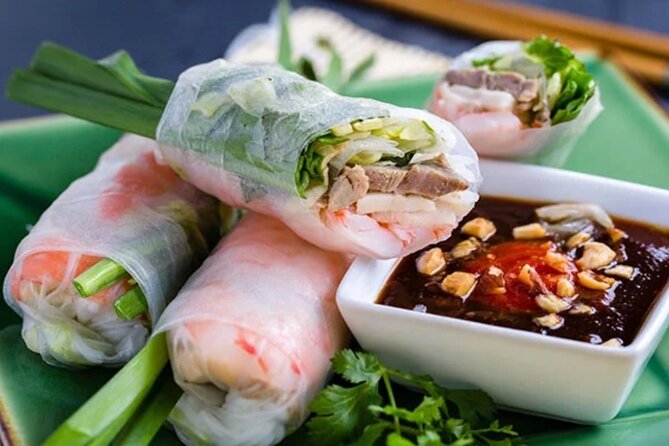 12 Tasting Street Food & Sightseeing By Scooter with Student - Sampling snack culture at Xom Chieu Market