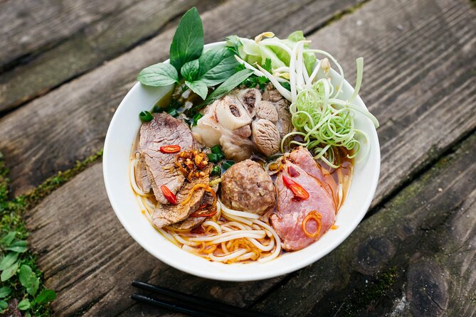 12 Tasting Street Food & Sightseeing By Scooter with Student - Starting with pho at 86 Mạc Đĩnh Chi